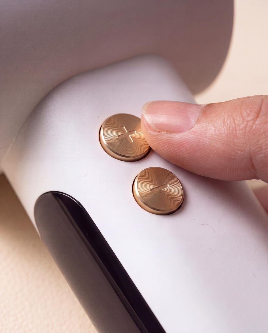 Close-up of the Halo's gold plus and minus buttons with a thumb adjusting the speed